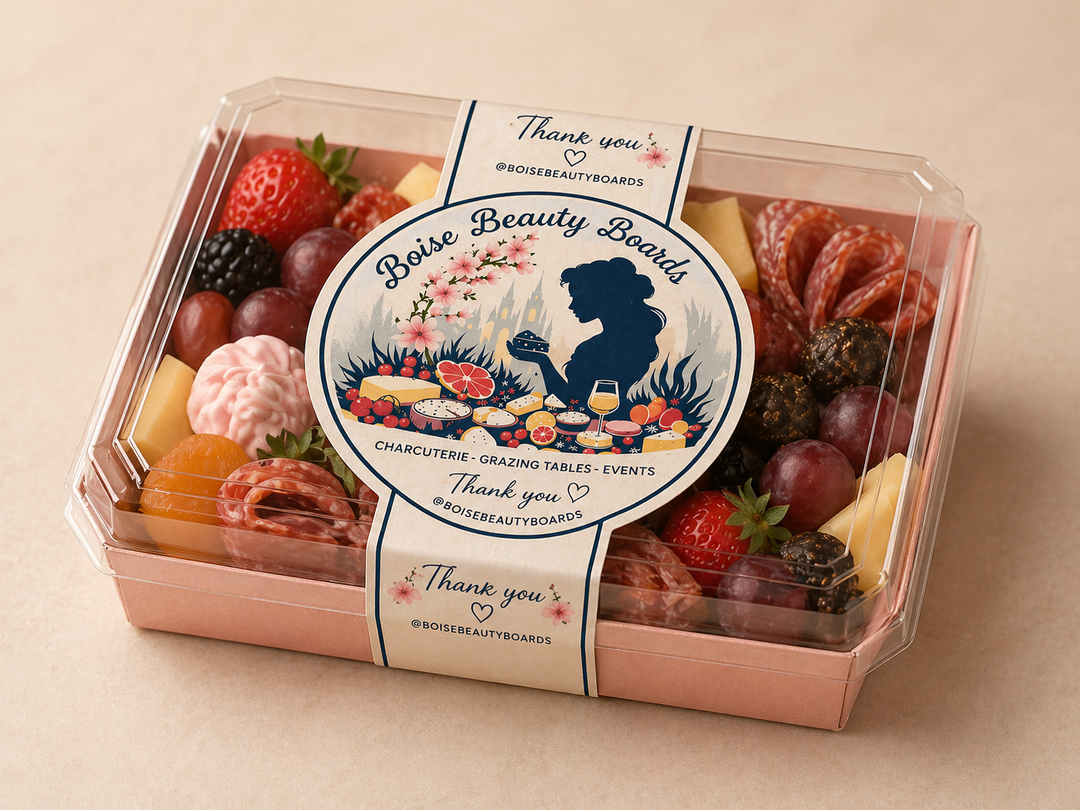 Boise Beauty Boards charcuterie board packaging with a decorative label on a beige background